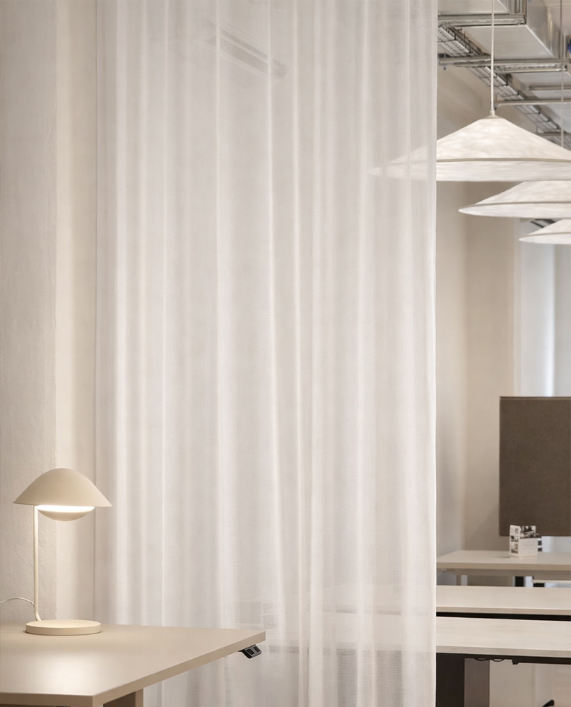 Decorquip white sheer curtain dividing a modern commercial office workspace