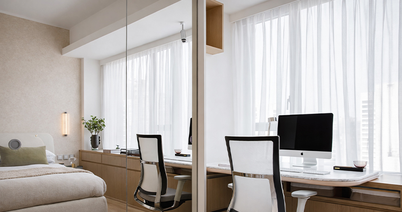 Decorquip white sheer curtains across large windows in a bedroom and home office space