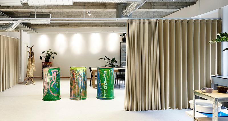 Decorquip beige wave curtains used as room dividers in a modern commercial interior