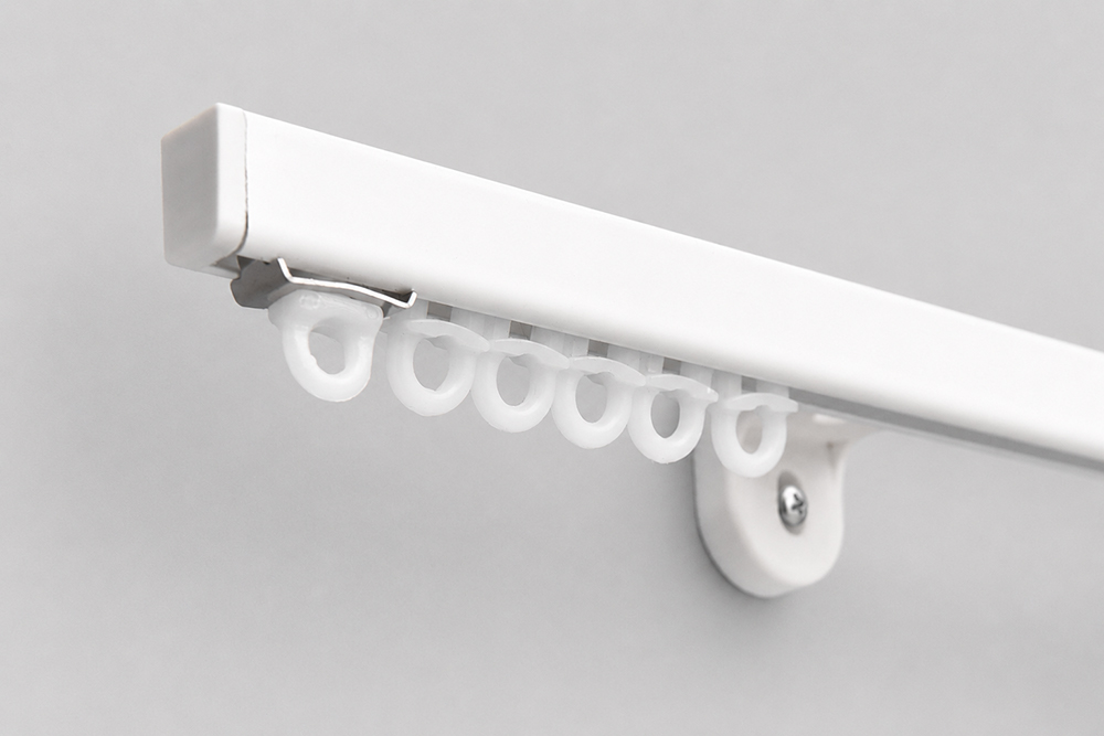 Decorquip white ACT50 curtain track with gliders and mounting bracket on a neutral studio background