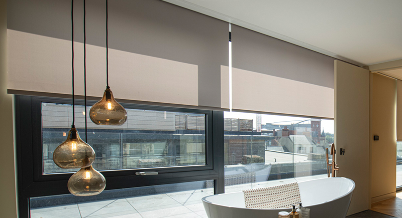 Decorquip grey roller blinds in Blindspace partially lowered over wide bathroom windows