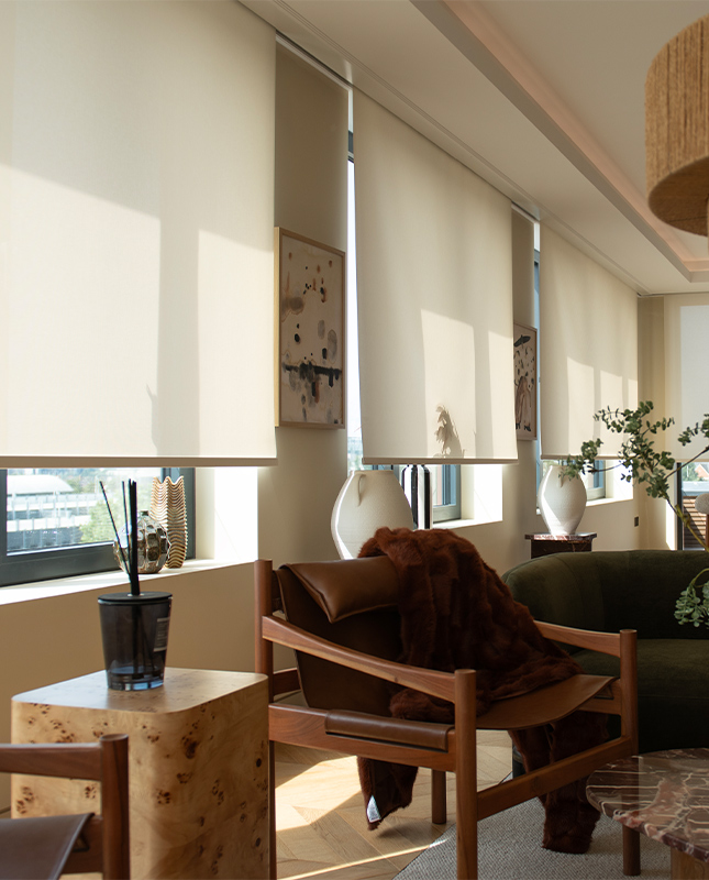 Decorquip cream Capital Collection motorised roller blinds lowered over tall living room windows