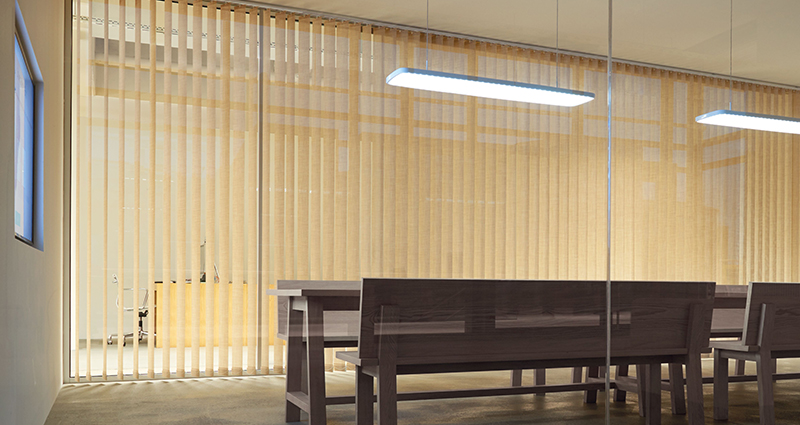 Decorquip beige Capital Collection vertical blinds across large windows in a modern office meeting room
