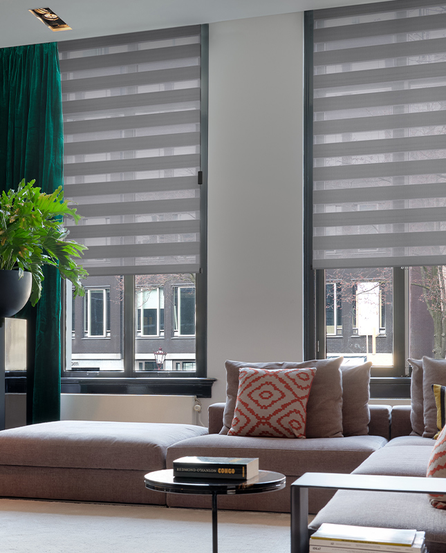 Decorquip grey day and night blinds partially lowered in a modern living room