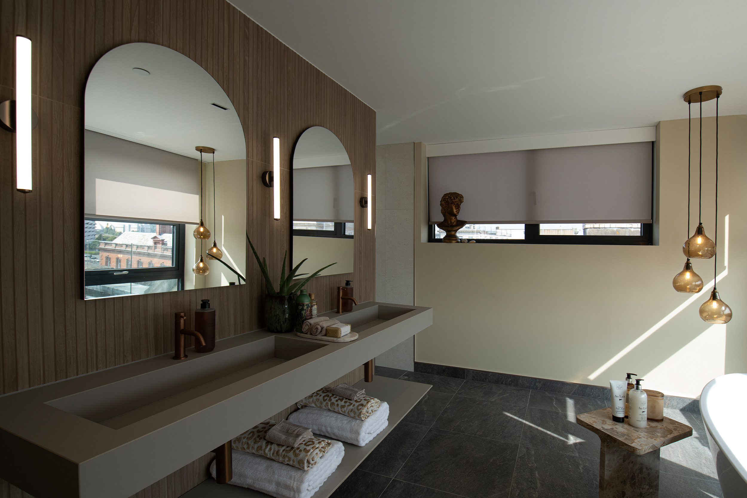 Decorquip grey roller blinds partially lowered over large bathroom windows
