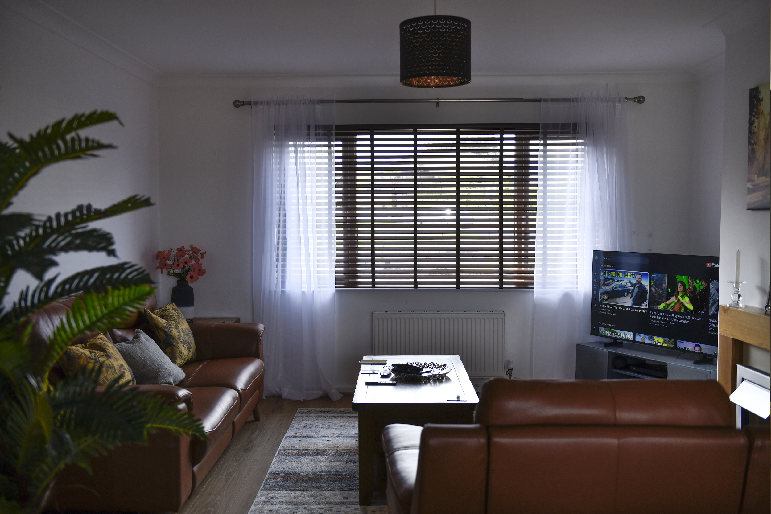 Decorquip dark faux wood Venetian blind fitted to a wide living room window