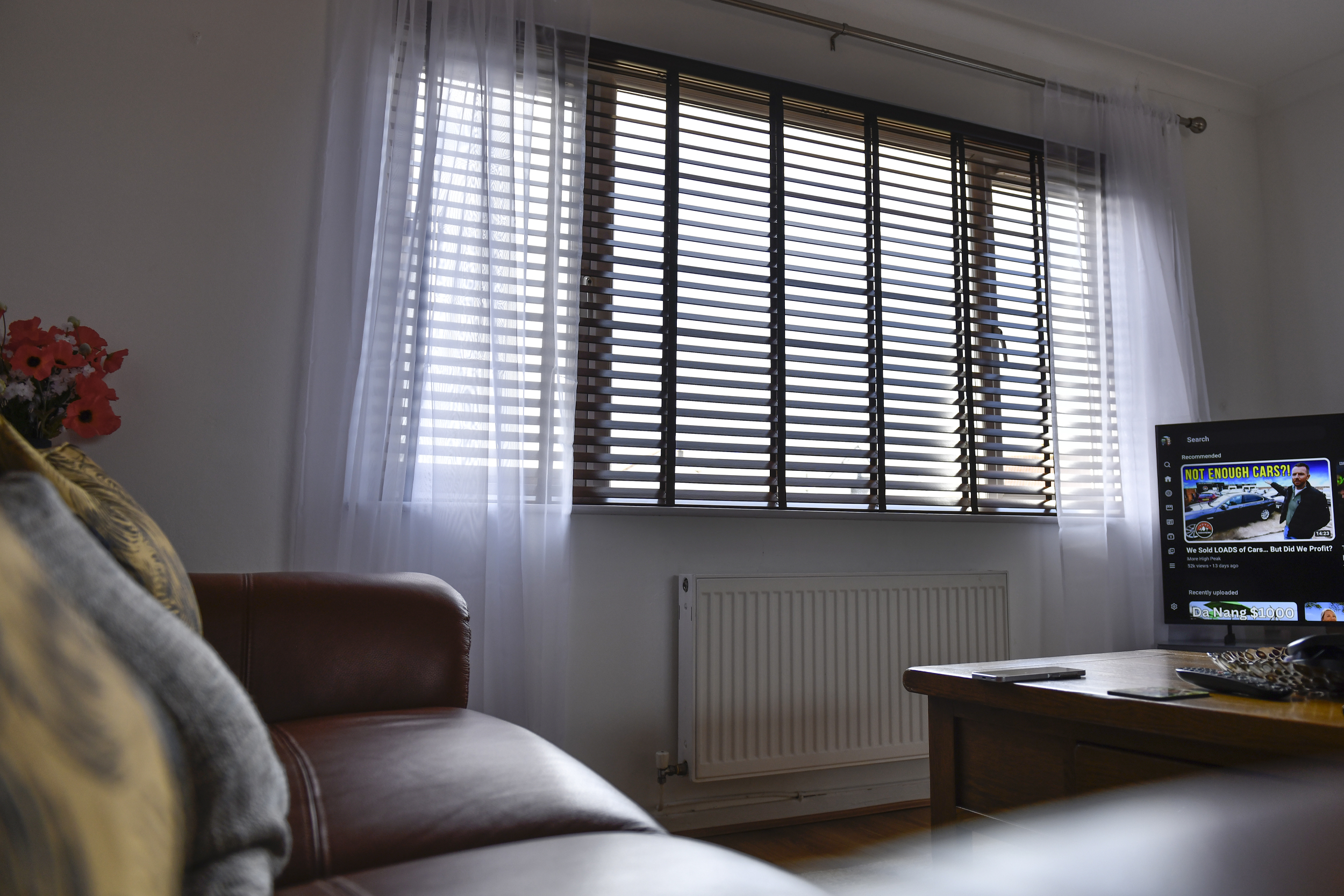 Decorquip dark faux wood Venetian blind fitted to a wide living room window