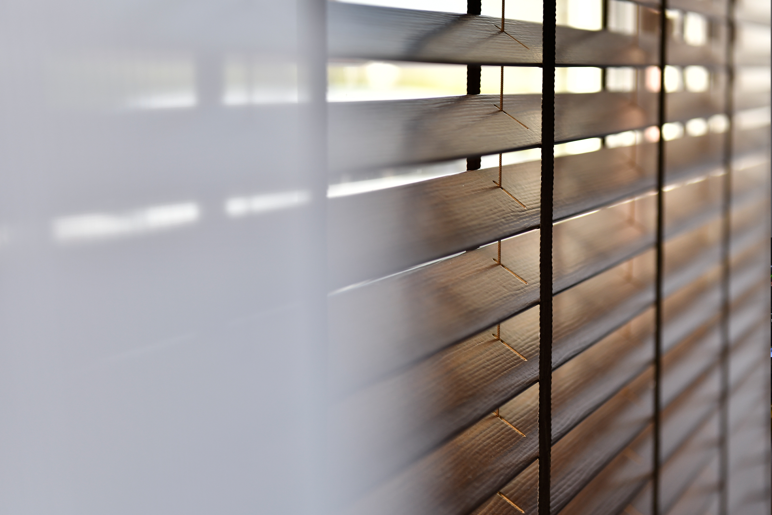 Decorquip dark faux wood Venetian blind fitted to a wide living room window