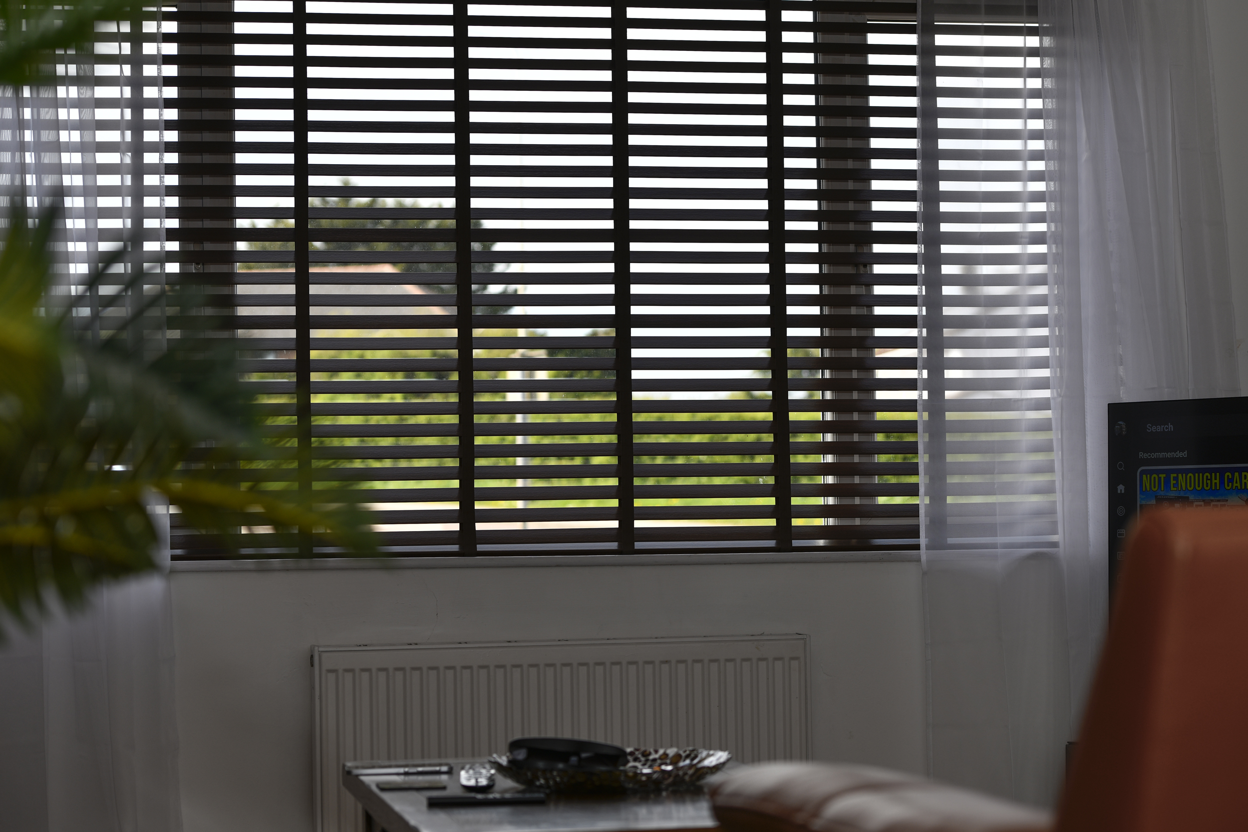 Decorquip dark faux wood Venetian blind fitted to a wide living room window