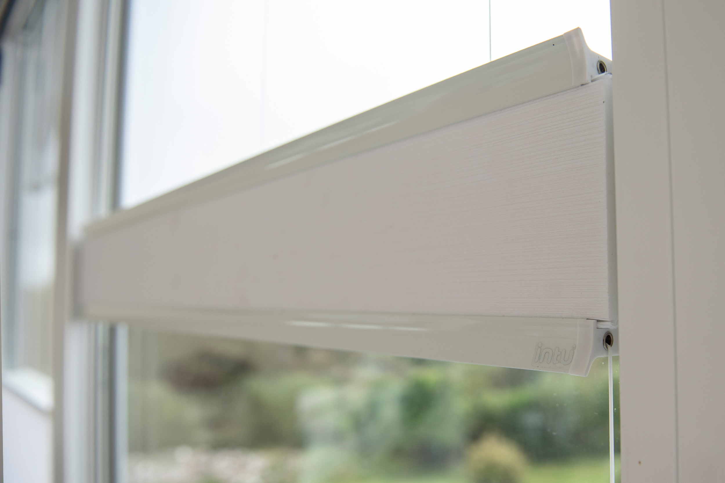 Decorquip white pleated blinds partially lowered across large bedroom windows