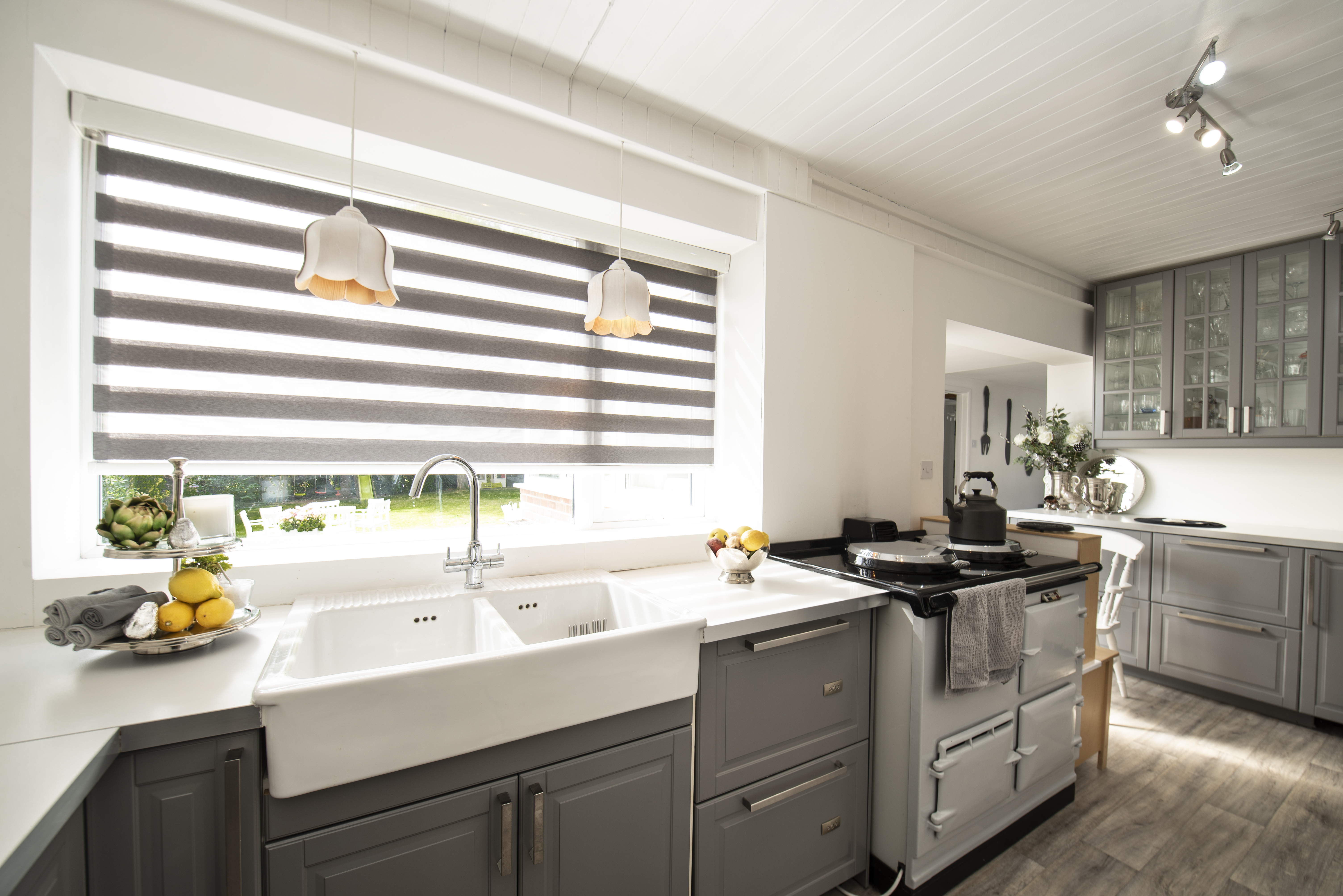 Decorquip grey day and night blind with alternating sheer panels above a white kitchen sink