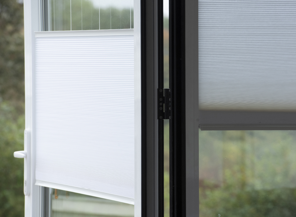 Decorquip white INTU pleated blinds fitted to glazed doors, shown partially lowered
