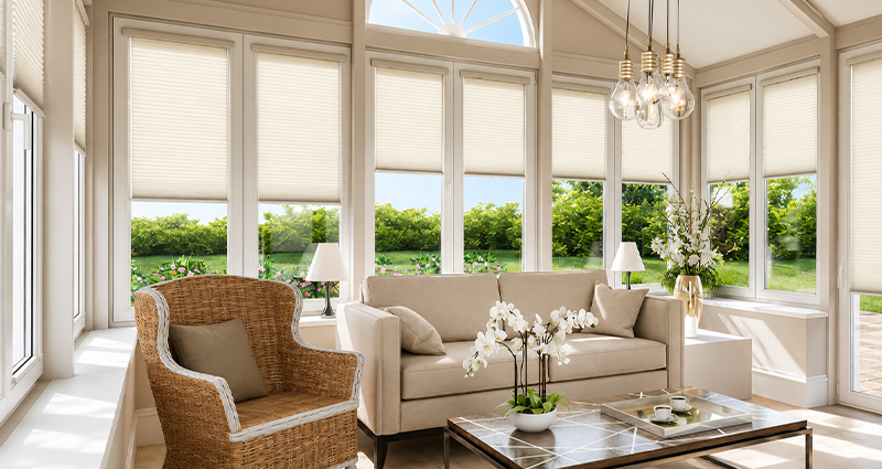Decorquip cream pleated blinds partially lowered across conservatory windows