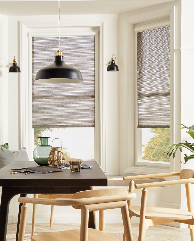 Decorquip grey textured Perfect Fit pleated blinds partially lowered in a bright dining room
