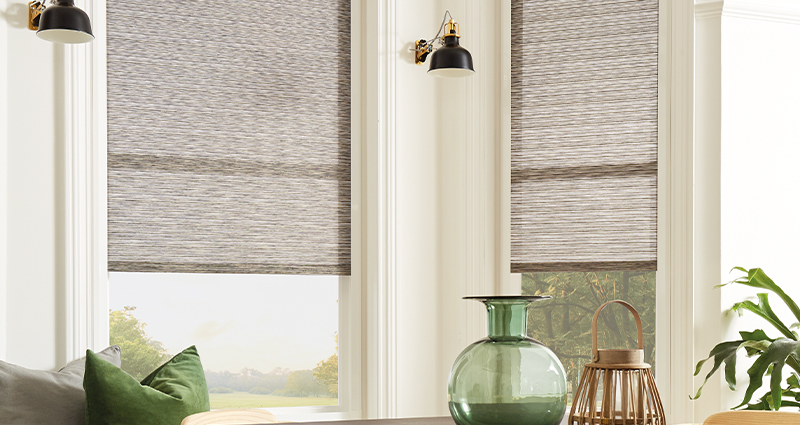 Decorquip grey textured Perfect Fit pleated blinds partially lowered over tall living room windows