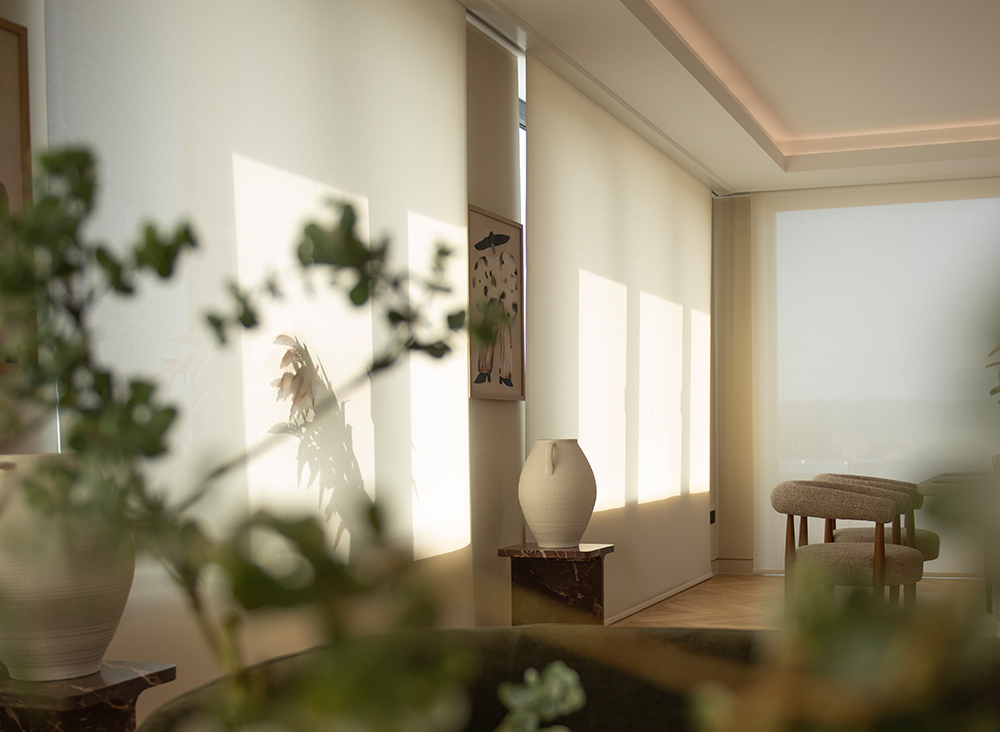 Decorquip cream Capital Collection motorised  roller blinds partially lowered over dining room windows